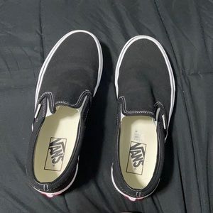 These are a size 8 women’s pair of black slip on vans